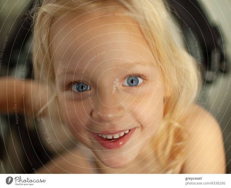 Looking at the world with a big smile portrait girl kid child people baby joy little home excited joyful toddler positive small cheerful childhood blue eyes