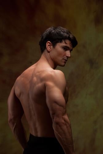 The sexy man shows off his strong muscles. hot guy stud hunk macho brazen muscular handsome heartthrob spooky vampire wicked stock images graphics inspirational