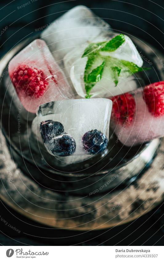 ice cubes with berries vitamins vegetarian food transparent cold fruit health frozen refreshment summer sweet tasty juicy background delicious cool raspberry