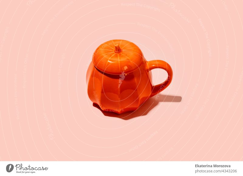 Ceramic Coffee tea soup cup as pumpkin on pink. Halloween concept, hard shadow, minimal party holiday october spooky orange mug beverage thanksgiving harvest