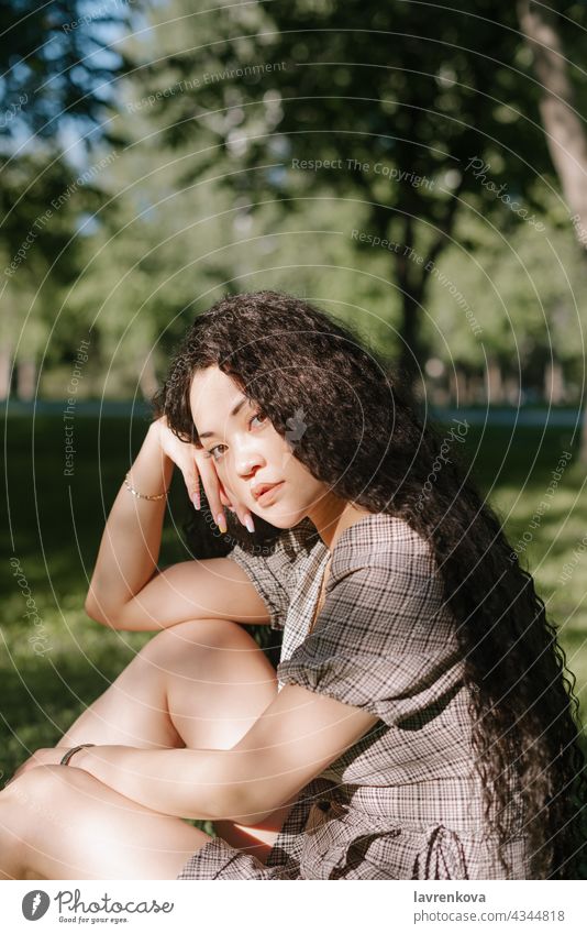 Young beautiful asian female sitting on the grass in a park dress happy woman people adult person lifestyle outdoors young summer meadow femininity romantic