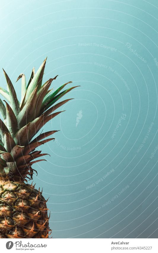 Minimalistic pineapple over a pastel blue background with copy space summer concept minimal pop art juice tropical composition exotic health isolated juicy