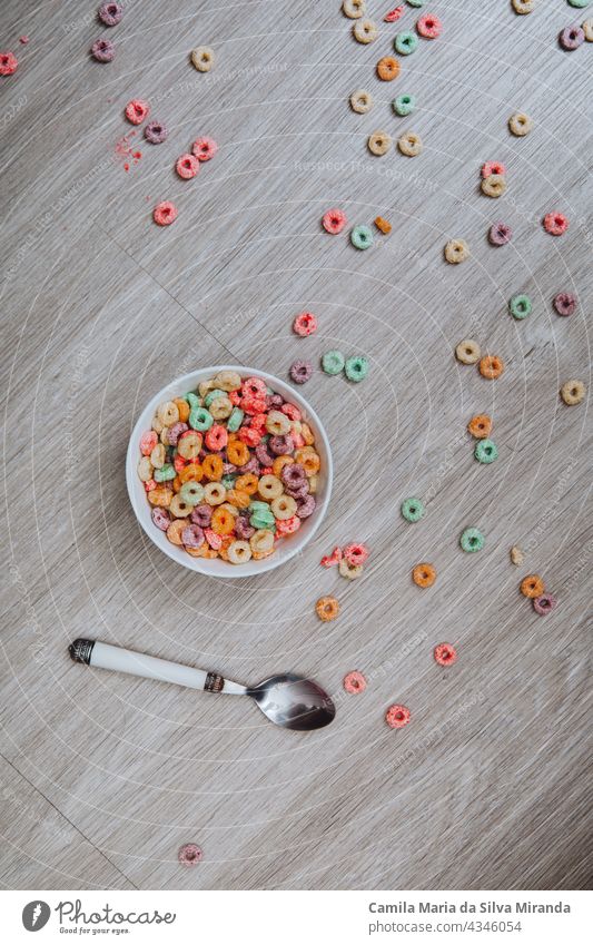 Colorful cereal  in a bowl with spoon on the floor. background box breakfast carbs colorful delicious dessert food fresh fruit green home kids loops milk