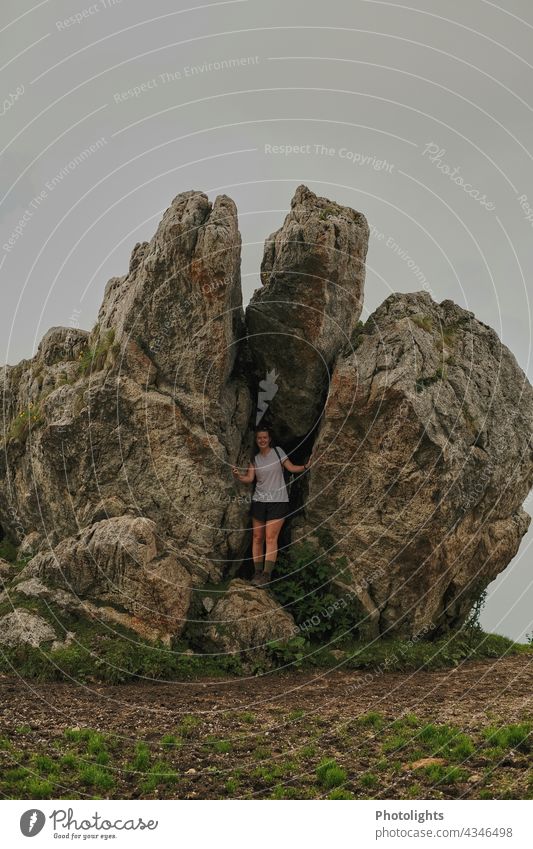 Young woman between two rocks Extreme Action trekking Vacation & Travel ascent Hiking Landscape rocky landscape Wall of rock Nature Mountain Exterior shot Peak