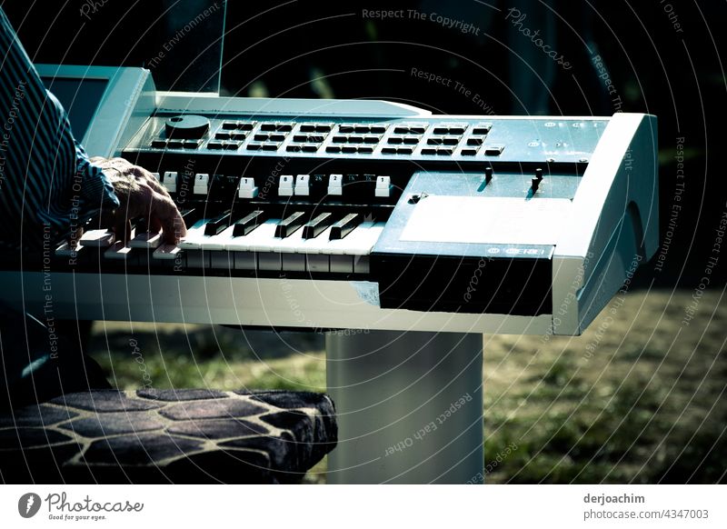 Today we're hitting the keys. Here plays the music. The keyboard system is on a lawn. Only the hand of the player can be seen. Keyboard Close-up Detail