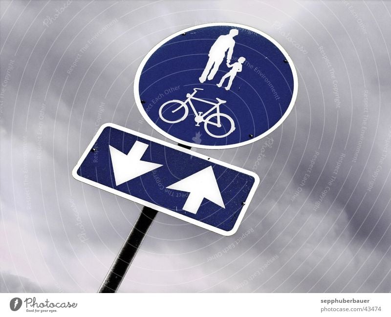 cycle path Bicycle Clouds Storm clouds Transport Road sign Signs and labeling Arrow Blue Gray Lanes & trails Cycle path Graphic Pedestrian Colour photo