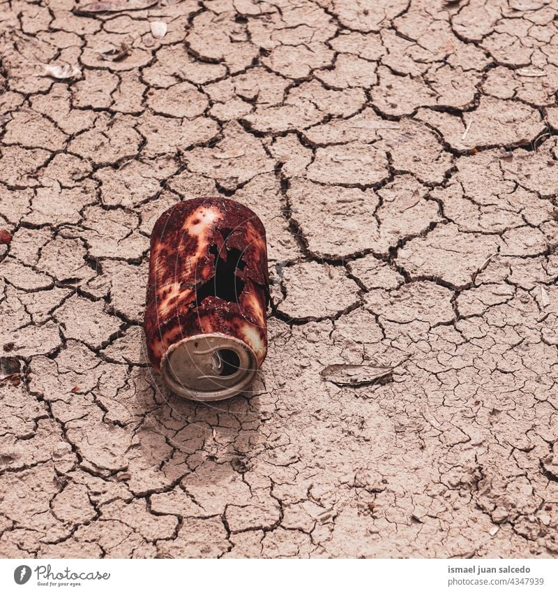 rusty can on the desert ground object still life brown old abandoned land dry textured earth nature climate pattern dirt arid sand surface environment