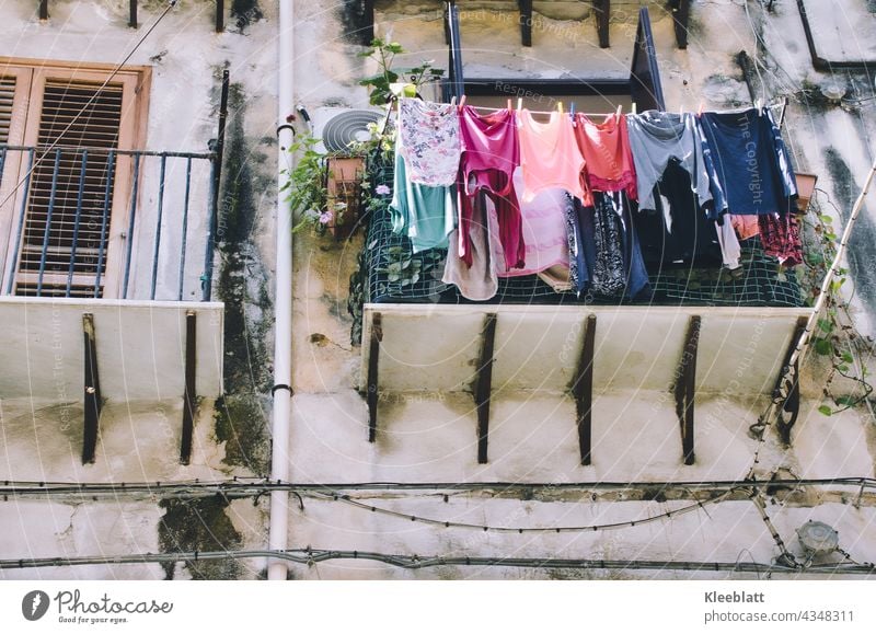 Washing day - fresh laundry hangs on the clothesline outside a balcony - typical south - view upwards Laundry Household Living or residing Clean Fresh Clothing