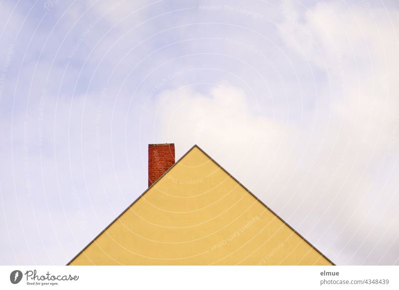 yellow, windowless gable wall of a residential house and red brick chimney in front of blue sky with clouds / live / triangle pediment house gables Chimney
