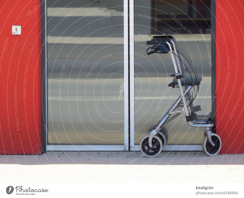 Rollator in front of a glass door Mobility Senior citizen Walking aid Exterior shot Human being Day Going Old Illness Colour photo To go for a walk handicap