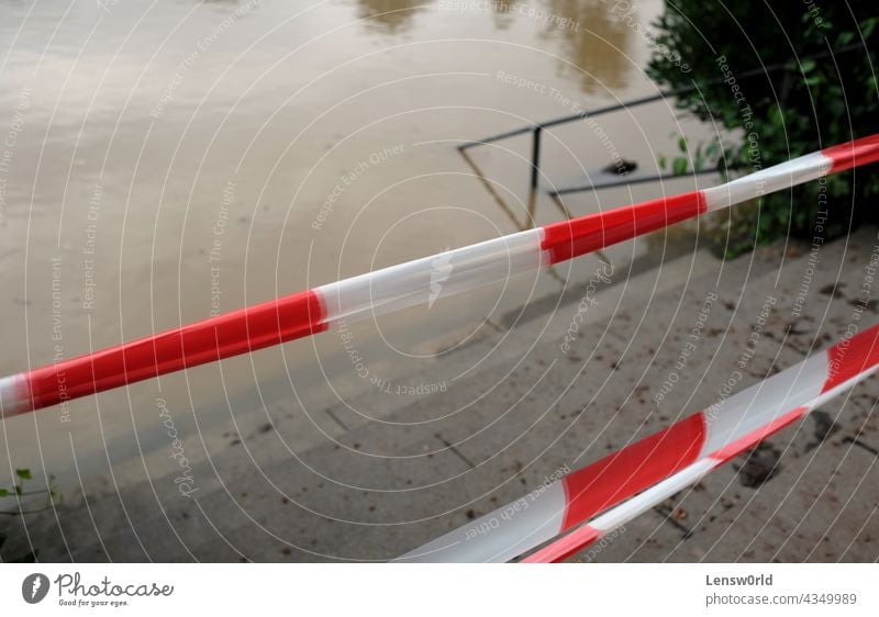 Extreme weather - closed park entrance following heavy rainfalls which turned a field in Düsseldorf, Germany, into a lake climate climate change disaster