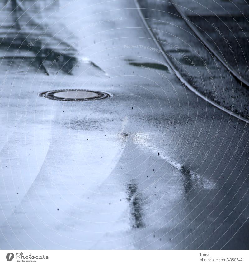 Track in asphalt with drain, puddle and reflection (2) Rail transport track Asphalt vibration curvature Parallel Water Damp Wet Gray manhole cover Puddle Gully