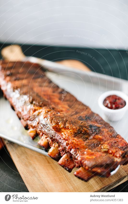 Rack of Ribs covered in barbecue sauce american background baked barbecued barbeque bbq beef board bones charcoal closeup cooked cooking cuisine delicious