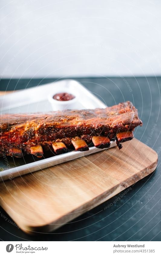 Rack of Ribs covered in barbeque sauce american background baked barbecue barbecued bbq beef board bones charcoal closeup cooked cooking cuisine delicious