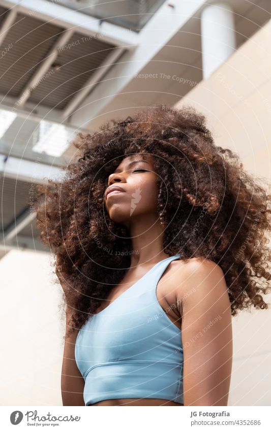 Young black woman closed eyes with curly hair style - a Royalty Free Stock  Photo from Photocase