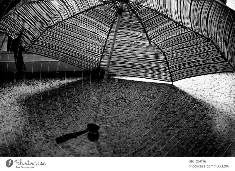 Umbrella stretched out to dry Umbrellas & Shades spanned lines terrazzo flooring points Ground Light Shadow Weather Wet Bad weather Climate Pattern