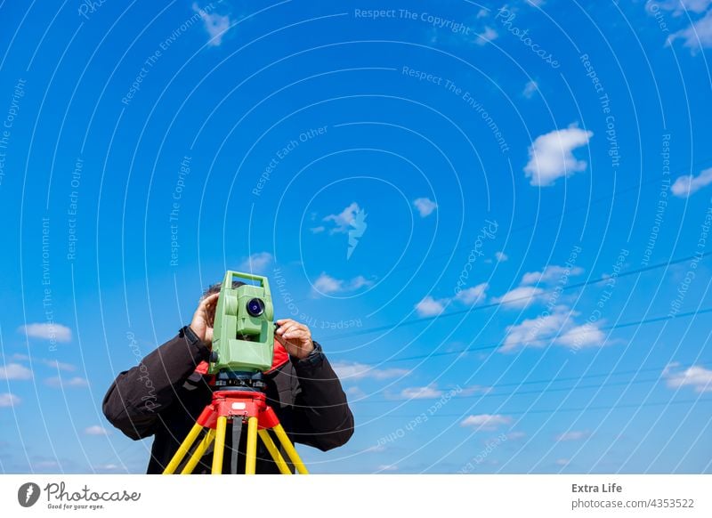 Civil engineer, geodesist is working with total station on a building site, blue sky in background Accuracy Appliance Building Site Checking Civil Engineering