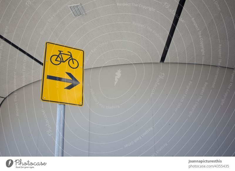 Traffic sign with bicycle in front of concrete wall Signs and labeling Transport Means of transport Road sign Road traffic Signage Traffic infrastructure Town