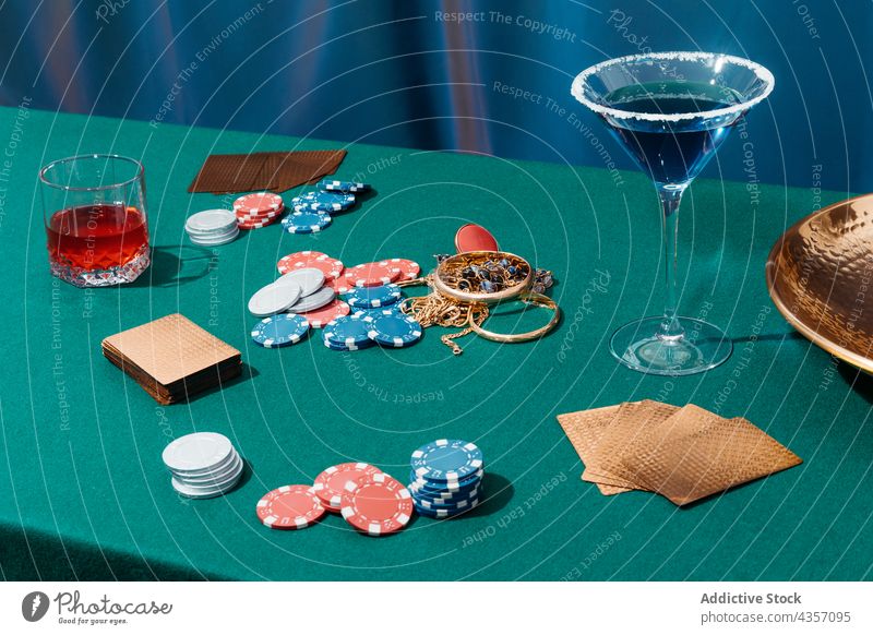Poker table with cards and chips poker bet game gamble alcohol cocktail nightlife entertain jewelry green drink amusement fortune luck win chance club casino