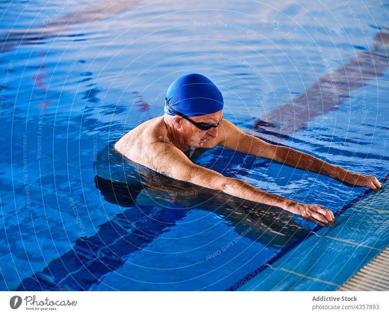 Man in swimming pool during water aerobics training man mature company exercise class aqua activity healthy practice workout body wellness vitality energy