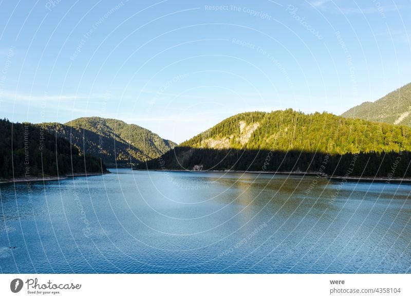View over the Alps and the Sylvenstein Reservoir on a sunny summer evening Sunset at the lake Waterfront alps blue sky clouds copy space evening sun landscape