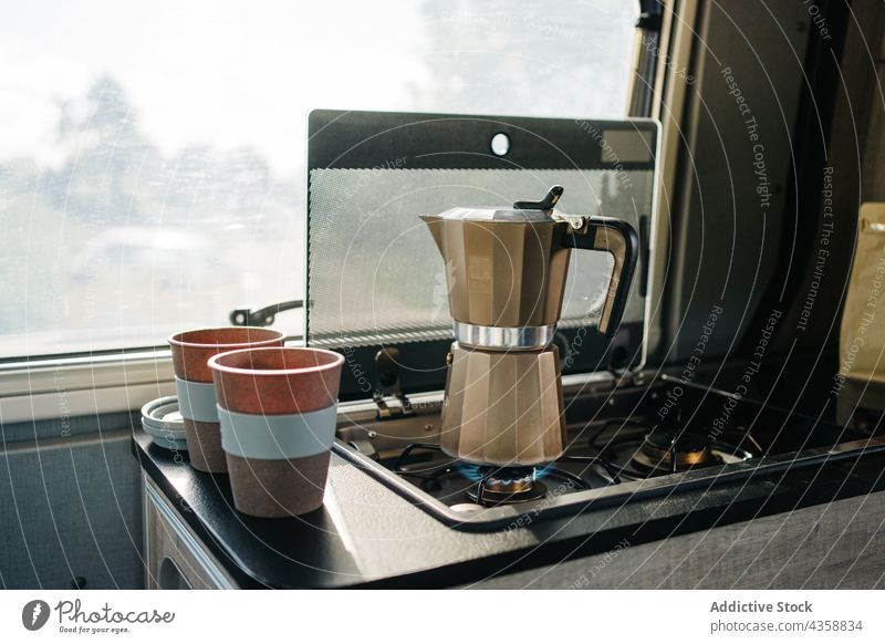 Coffee warming up in the kitchen of a motorhome coffee coffee maker caffeine cup hot drink van transportation car lifestyle travel journey vehicle camper