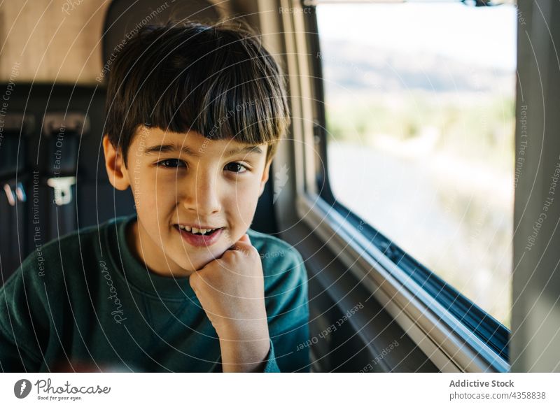 Little boy sitting inside a motorhome child person travel vacation indoors males childhood day motor home journey kid one person relaxation road trip adventure