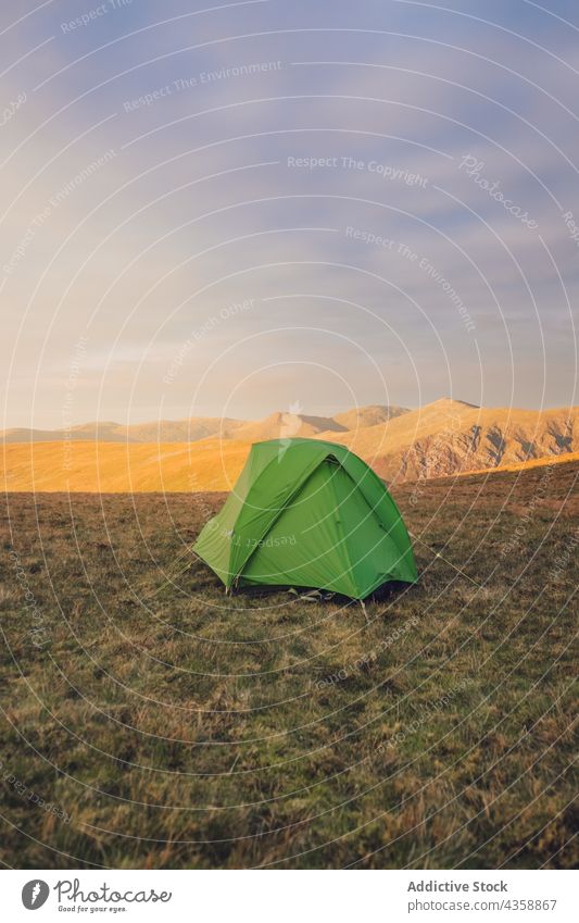 Tent placed on hill in mountainous terrain tent camp campsite highland sunset valley environment grass wales united kingdom uk great britain scenic scenery