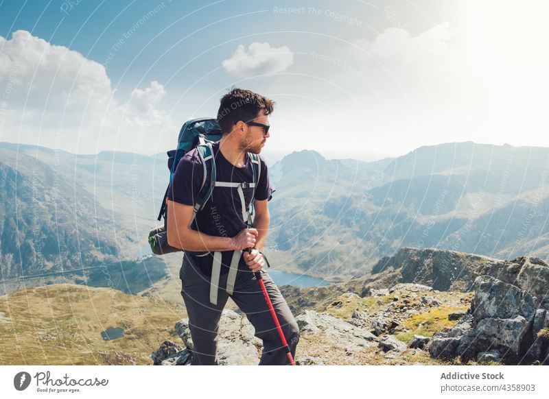 Male hiker with trekking pole in mountains man traveler highland summer sunny male wales united kingdom uk great britain adventure backpack activity nature