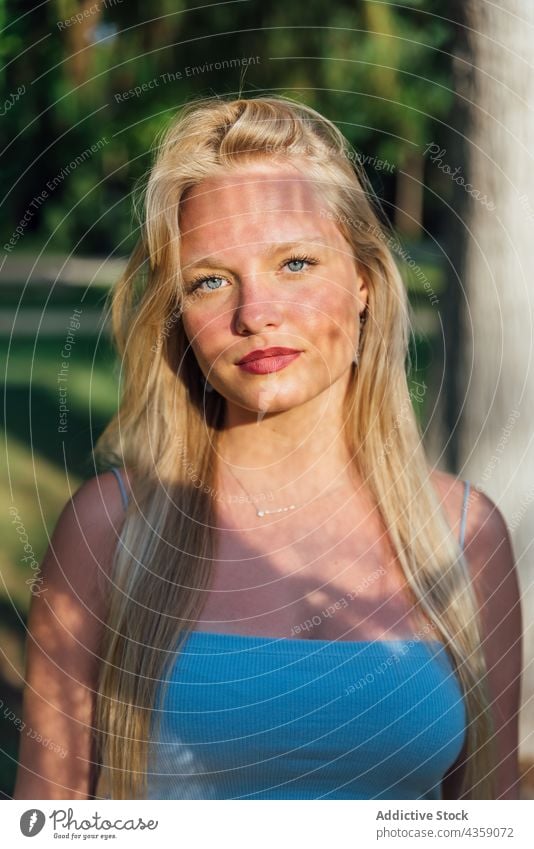 Smiling woman with ornamental shadow on face in summer park shade sunny charming beauty appearance female smile sunlight positive nature happy cheerful blond
