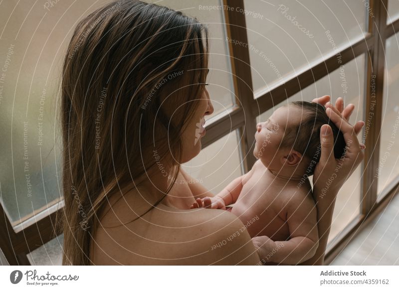 Gentle mother with sleeping newborn at home infant naked together love tender baby care adorable cute child window parent little babyhood eyes closed gentle