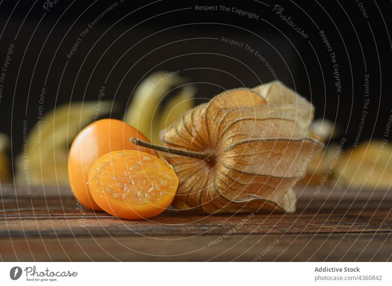 Background of Aguaymanto Peruvian GroundCherry berry fruit cape healthy husk orange peruvian food gooseberry physalis isolated tropical yellow background diet
