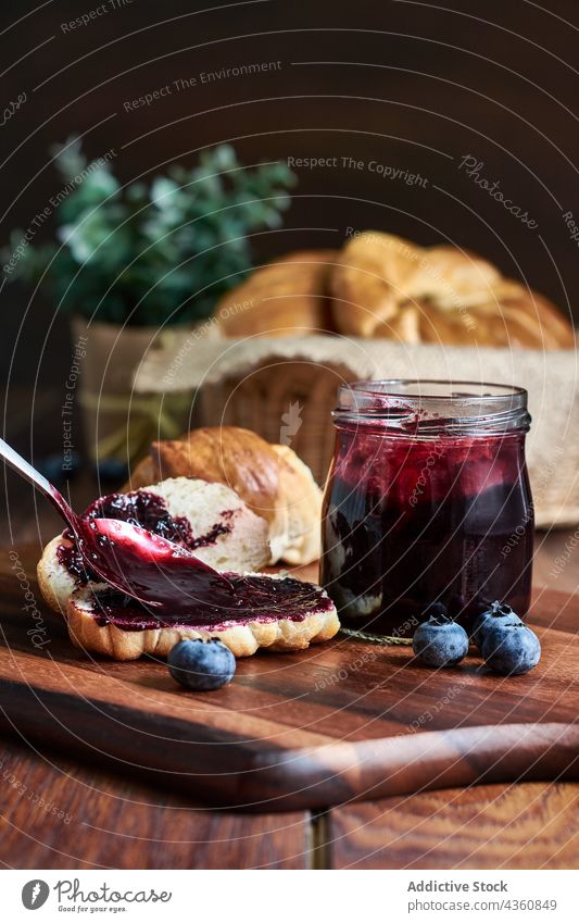 Croissants with blueberry jam on a wooden table croissant breakfast food sweet dining fit energy rustic still fruits dessert spoon blueberries pot blur