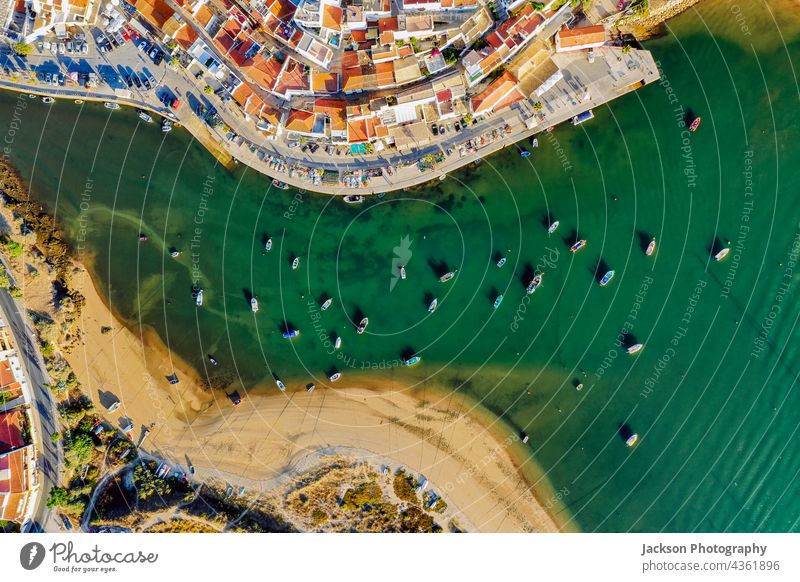 Aerial cityscape of Ferragudo by Arade River, Algarve, Portugal ferragudo portugal algarve aerial river arade ocean architecture above top coastline waterfront