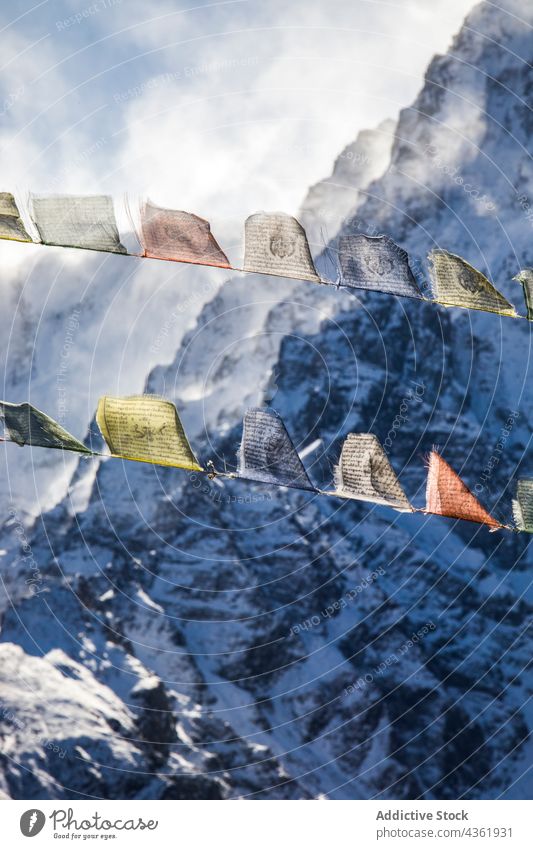 Colorful prayer flags in snowy mountains buddhist row colorful highland winter rock himalayas nepal tradition range ridge buddhism formation holy culture season