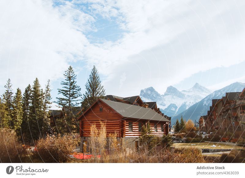 Wooden houses on riverside in mountainous terrain autumn landscape nature environment highland wooden picturesque scenery travel tourism banff national park
