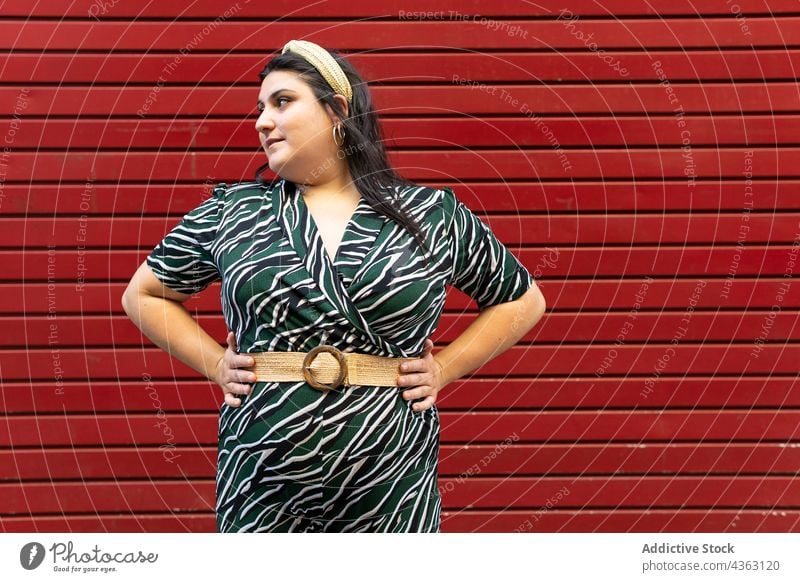 Portrait of happy stylish woman against red wall - a Royalty Free Stock  Photo from Photocase