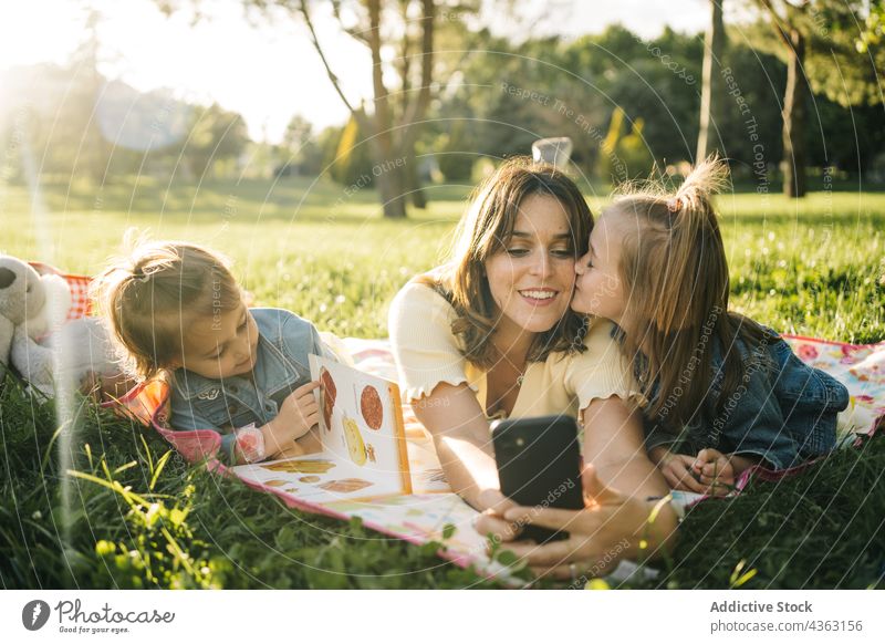 Cheerful mother and kids taking selfie in park summer having fun together happy smartphone sibling cheerful love mom sister watch laugh relationship child