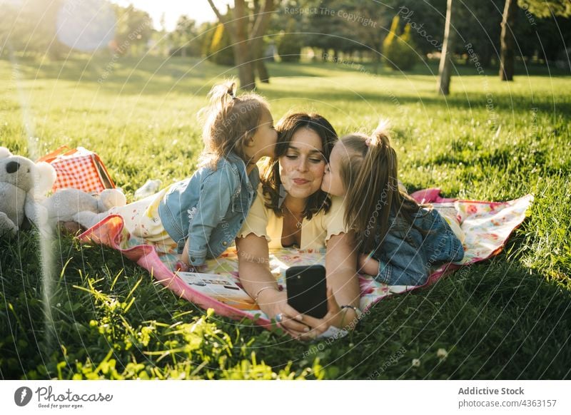 Cheerful mother and kids taking selfie in park summer having fun together happy smartphone sibling cheerful love mom sister watch laugh relationship child