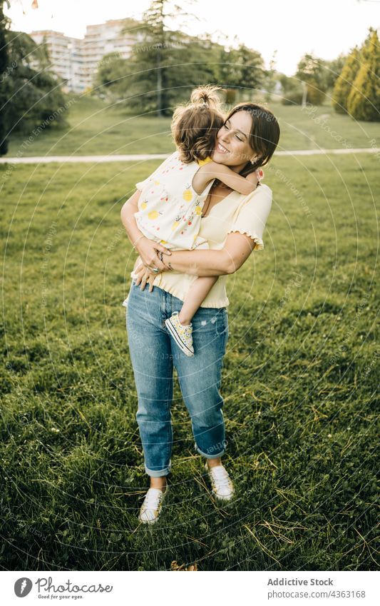 Young woman with toddler daughter in park mother together summer love kid happy cute child mom relationship little bonding lifestyle fondness affection tender