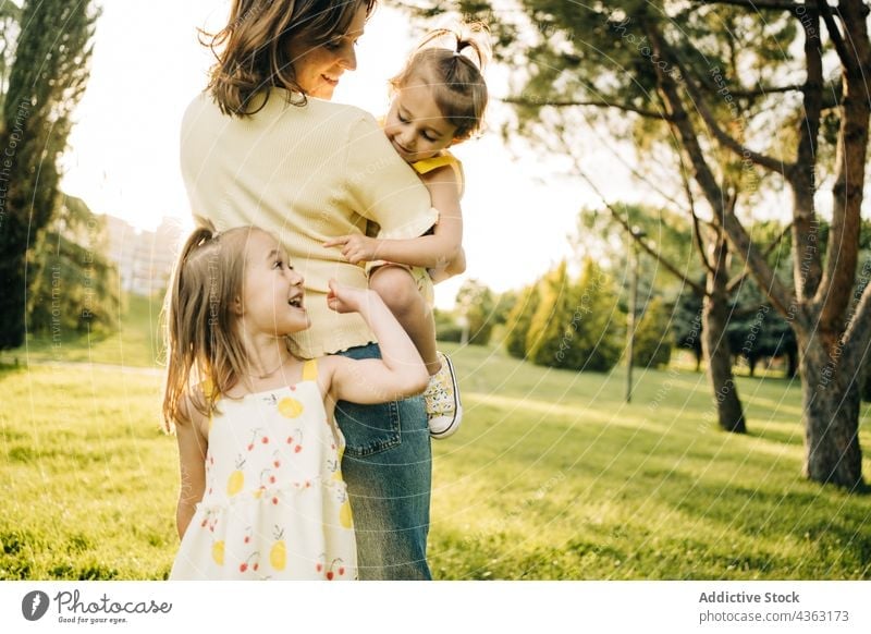 Mother spending time with children in park mother kid together love summer daughter sibling happy cute mom relationship little sister bonding lifestyle fondness