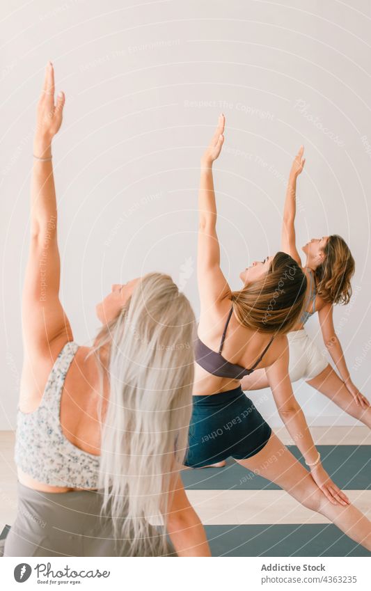 Group of women doing yoga in Reverse Warrior pose - a Royalty Free Stock  Photo from Photocase