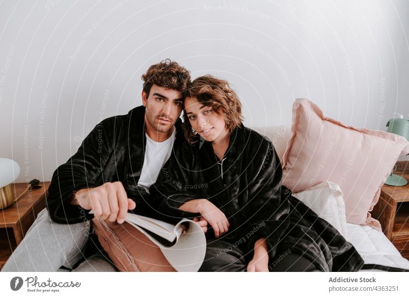 Loving couple embracing on sofa at home love bathroom chill together embrace hug tender couch rest comfort content cozy cuddle enjoy relationship relax happy