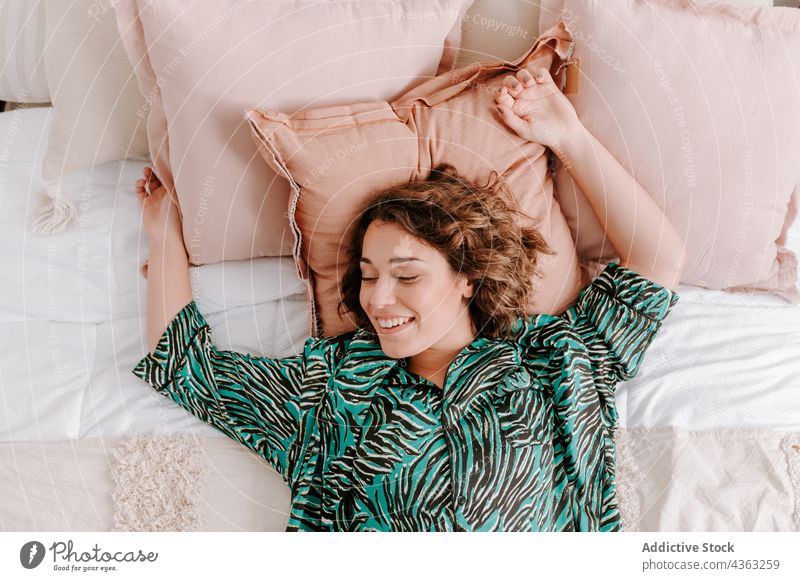 Tranquil woman lying on bed at home rest chill domestic bedroom serene peaceful female comfort calm relax apartment cozy weekend harmony tranquil soft flat