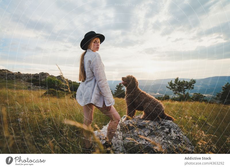 Woman with fluffy dog on meadow woman labradoodle friend animal pet owner female canine mountain together loyal breed nature companion countryside best friend
