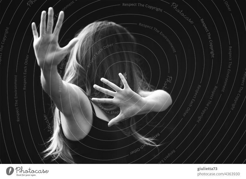 Portrait about violence against women | No - Stop - Halt! | Young woman with raised hands, trying to fend off violence portrait Black & white photo Woman White