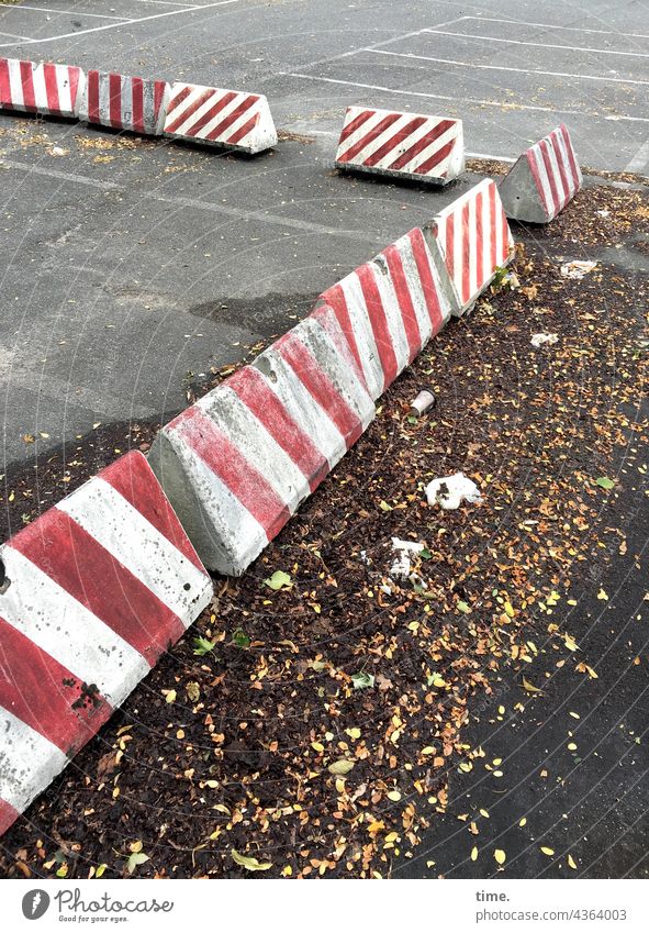 Gaps | Holes in the system Stone roadblocks foliage Parking lot Concrete concrete barrier Barrier Red White Canceled demarcated marked Rectangle Trashy Broken