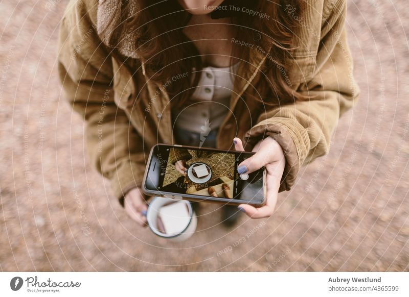 woman taking an overhead shot with her cell phone 18-25 20-25 autumn blue camping cheers community cook cookware culinary drinking hot chocolate enamel