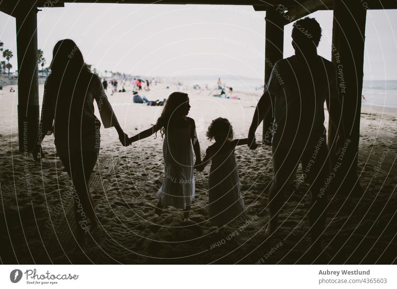 Silhouette of family walking under a pier 0-5 5-10 beach california dad daughters fall girls holding hands landscape little mom ocean outdoors pacific beach