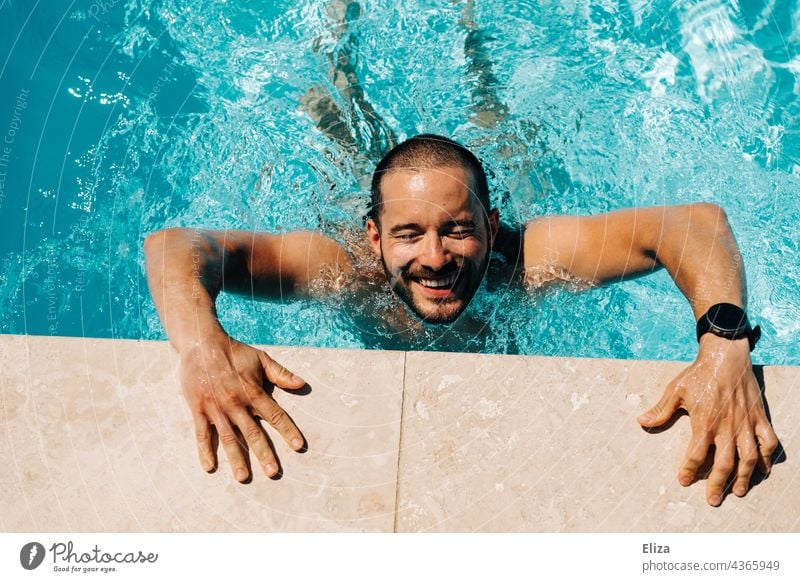 Laughing man propping himself on the edge of a pool Man laughing Swimming pool cheerful Water Summer bathe splashing sunshine Pool border Swimming & Bathing Joy
